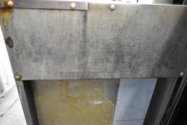 Cook Rite stainless steel deep fat fryer in used condition, featuring two metal fry baskets, mounted on commercial casters.