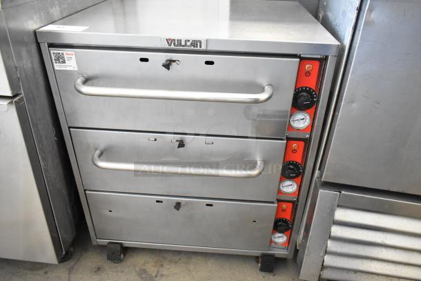 Vulcan stainless steel commercial warming drawer with 3 drawers and temperature controls, on casters, in good condition.