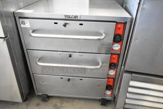 Vulcan stainless steel commercial warming drawer with 3 drawers and temperature controls, on casters, in good condition.