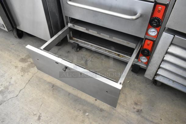 Vulcan stainless steel 3-drawer warming drawer on casters, open drawer showing interior, commercial use.