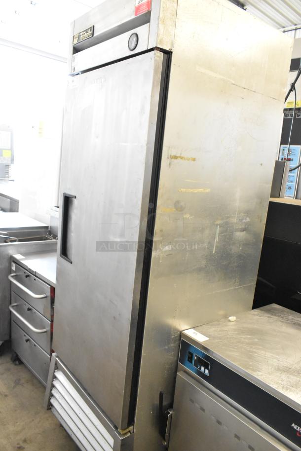 True T-23 stainless steel single door reach-in cooler, on commercial casters. Features True logo, 115 volts, 1 phase.