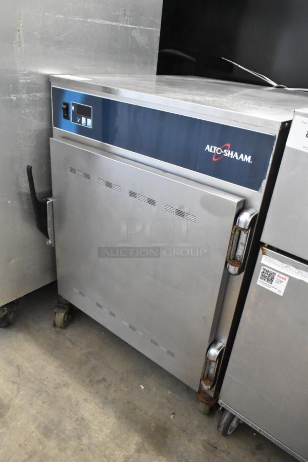 Alto Shaam 750-S stainless steel commercial heated holding cabinet on casters, 120V, 1 phase, visible wear, Alto Shaam logo.