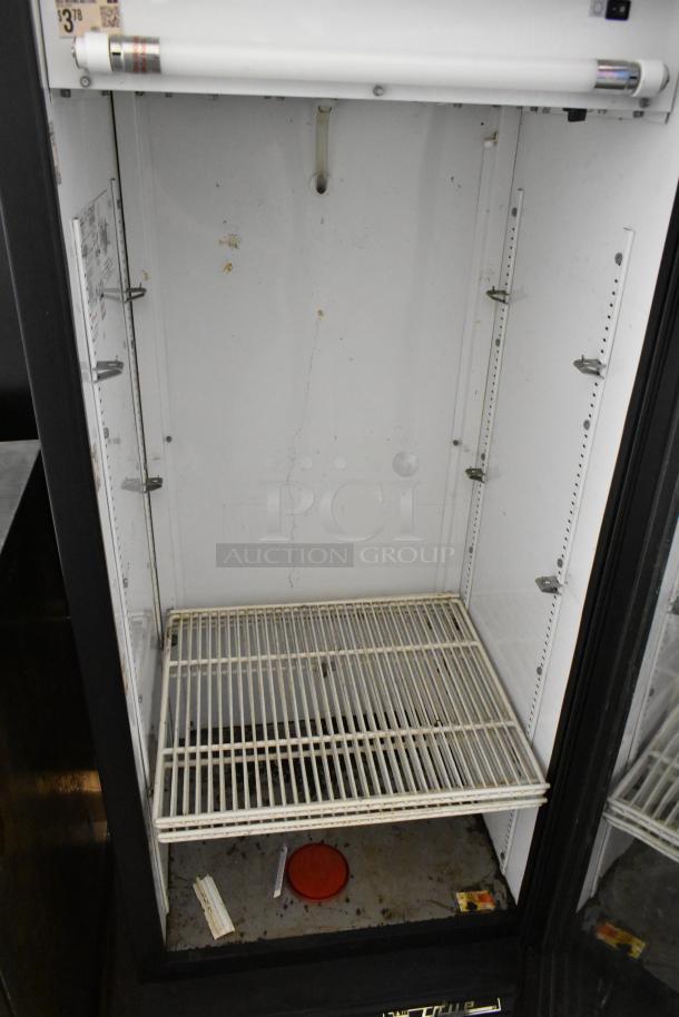 True GDM-12 commercial single door cooler with poly coated racks, metal construction, 115V, 1 phase. Interior shows wear.