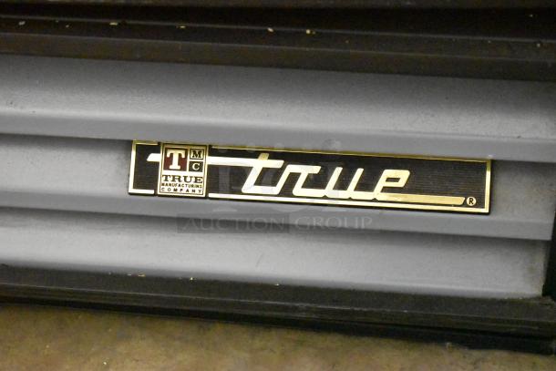 True GDM-12 metal cooler merchandiser with poly-coated racks, 115V, 1 phase; visible True logo label.