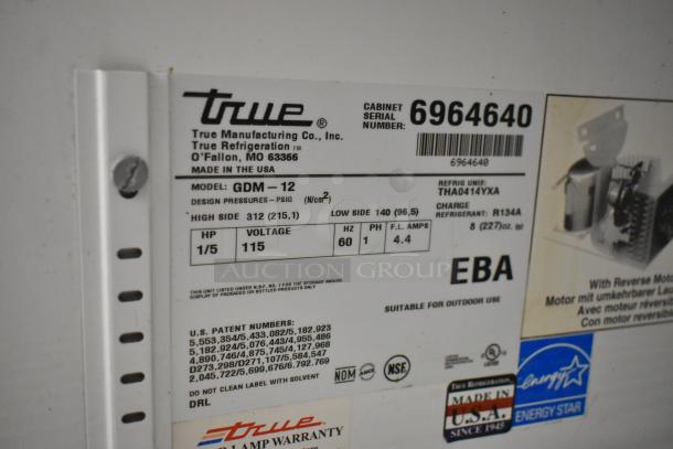 True GDM-12 commercial cooler label showing model, voltage (115V), phase (1), refrigerant (R134A), and serial number 6964640.