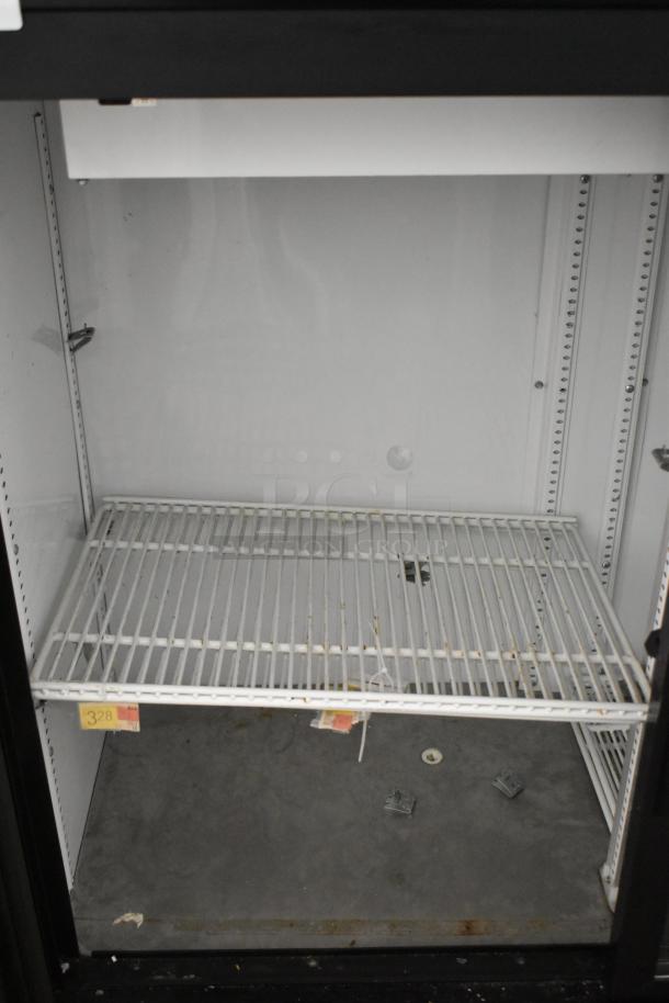 True GDM-41SL-48-HC-LD commercial cooler, 2-door, metal, poly racks, 115 volts, 1 phase; interior visible, fair condition.