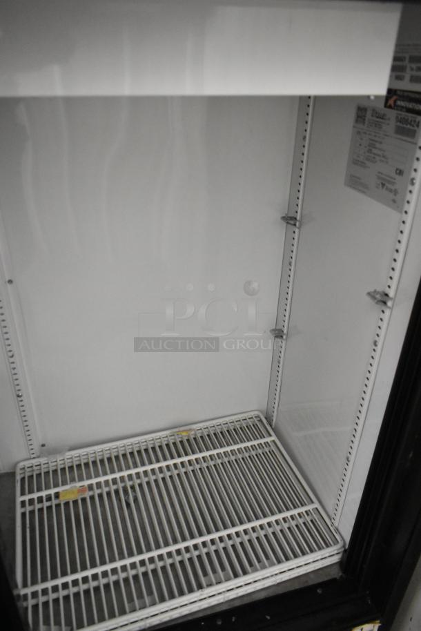 True GDM-41SL-48-HC-LD 2-door reach-in cooler, features poly-coated racks, in good condition, 115V, 1 Phase.