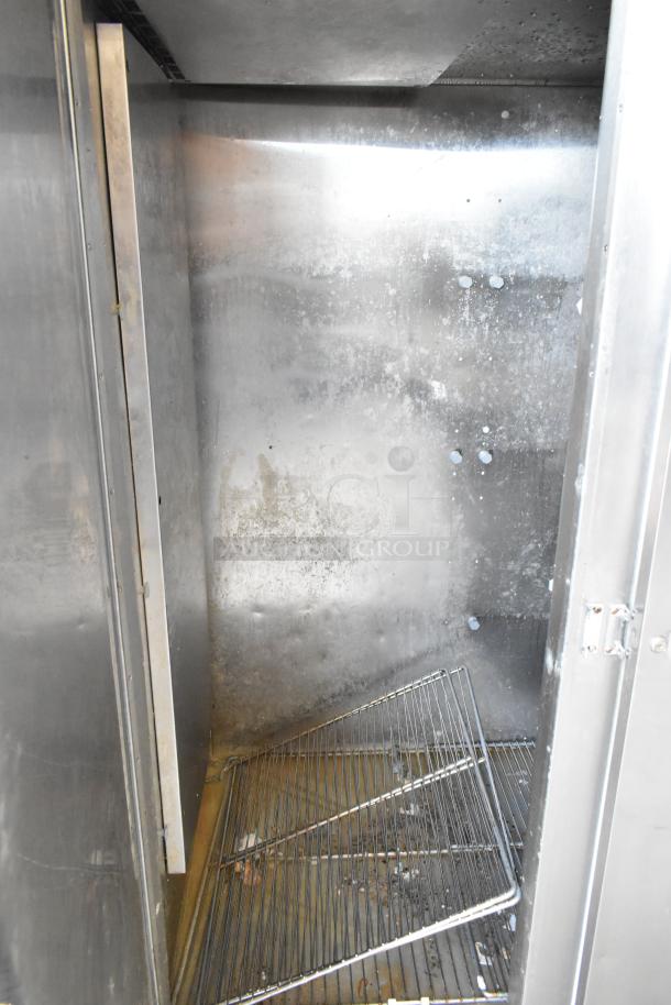Traulsen RL332N-ZBY01 stainless steel commercial freezer interior with poly coated racks, showing wear. 3-door design, 115V, 1-phase.