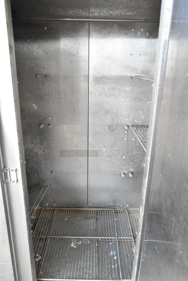 Traulsen RL332N-ZBY01 stainless steel commercial 3-door reach-in freezer interior with poly-coated racks, 115 volts, 1 phase.