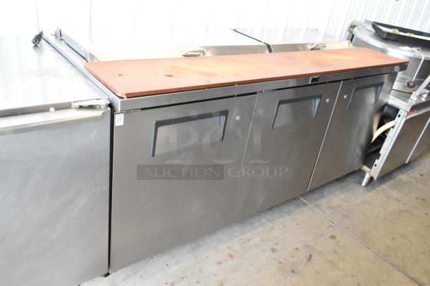 True TSSU-72-18-ST stainless steel pizza prep table, commercial casters, 115V, 1 phase, three doors, used condition.