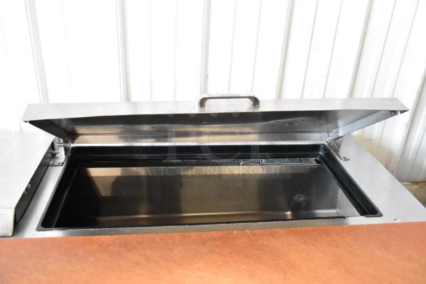 True TSSU-72-18-ST stainless steel pizza prep table with open lid, commercial casters, and 115V, 1-phase power.