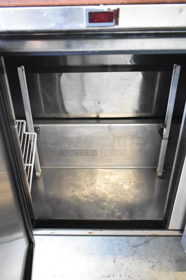 True TSSU-72-18-ST stainless steel commercial pizza prep table with visible interior compartment and digital display. Appears used.