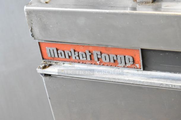 Market Forge MT40 stainless steel steam kettle, 40-gallon, commercial floor style, visible wear, brand label shown.