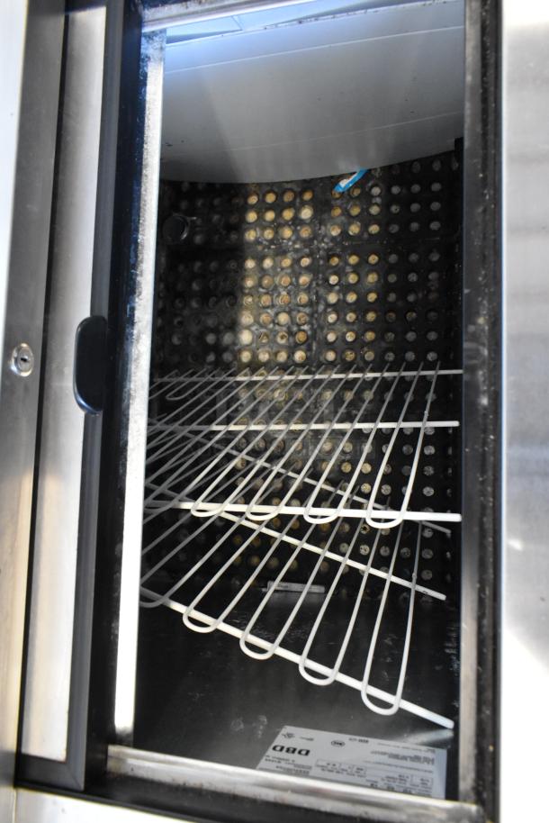 True TD-50-18 stainless steel back bar cooler interior, featuring wire shelving and ventilation panel. 115 volts, 1 phase.