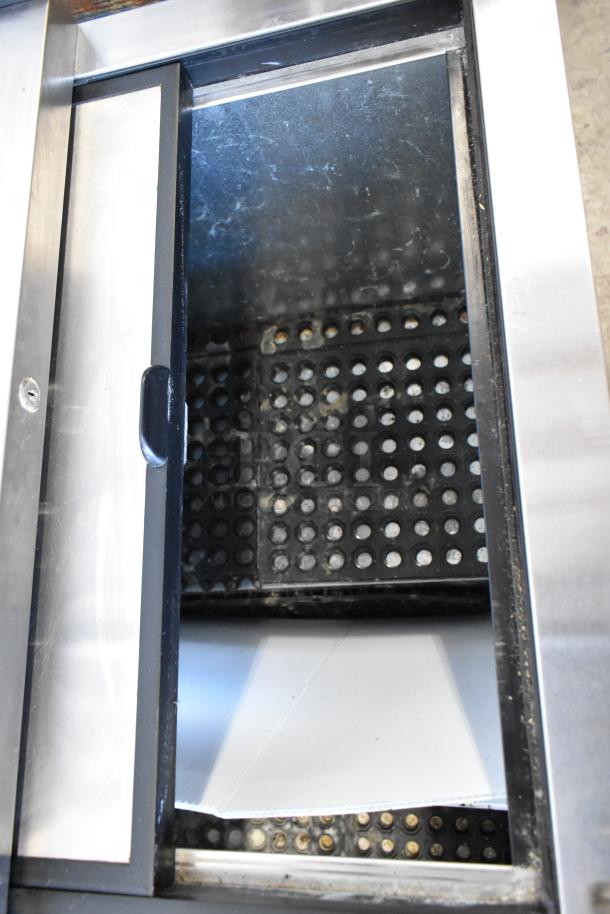 True TD-50-18 stainless steel back bar cooler with two sliding lids, 115 volts, 1 phase. Appears in used condition.