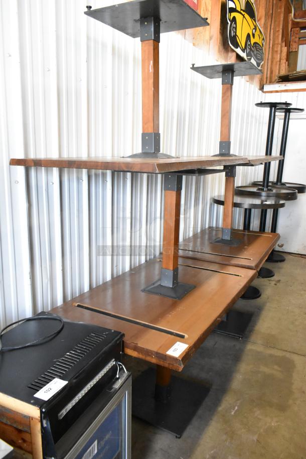 Six wooden dining height tables with metal bases, good condition, ideal for restaurants or cafes. Auction item, tags indicating lot numbers.