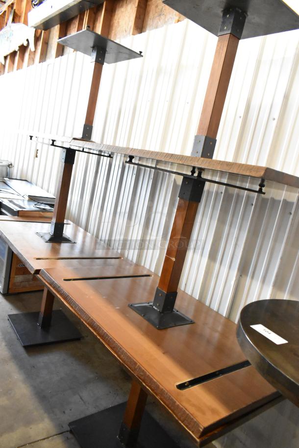 6 wooden dining height tables stacked, featuring sturdy metal bases, in good condition.auction tag visible.