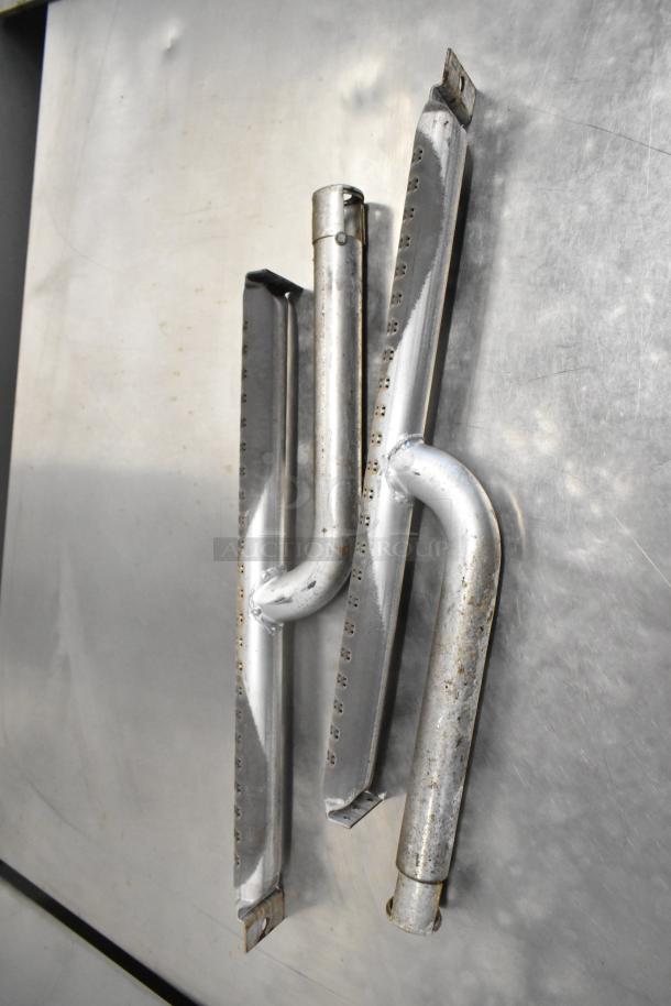 Stainless steel replacement parts for Cleveland 24CGM200 convection steam cabinet, showing wear and some rust, on a metal surface.
