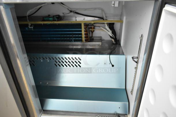 Yukon YUC-72F stainless steel 3-door undercounter freezer interior, showing commercial casters and internal components.