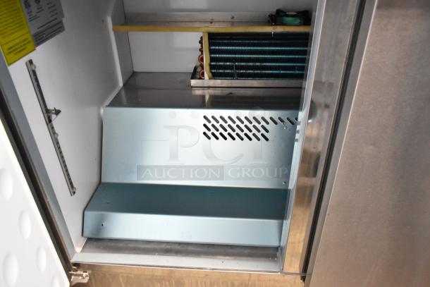 Yukon YUC-72F stainless steel commercial 3-door undercounter freezer interior, visible cooling coils, on casters, 115V.