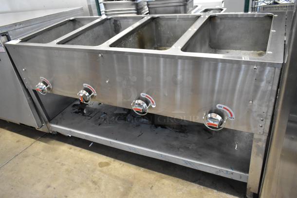 Stainless steel commercial gas-powered 4 burner steam table with under shelf; features easy-access knobs; used condition.