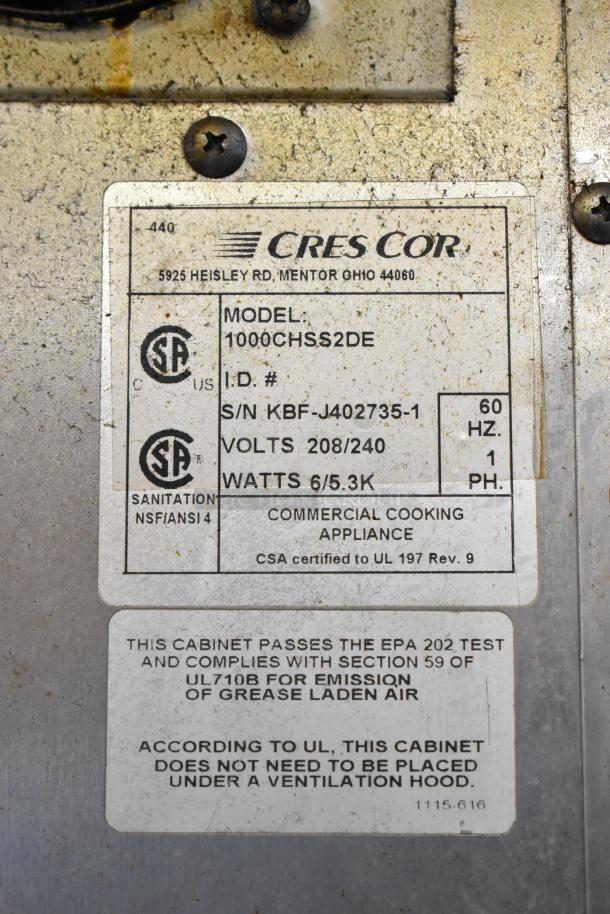 CresCor 1000CHSS2DE label showing model and specifications; stainless steel heated holding cabinet on casters. Top door issue.