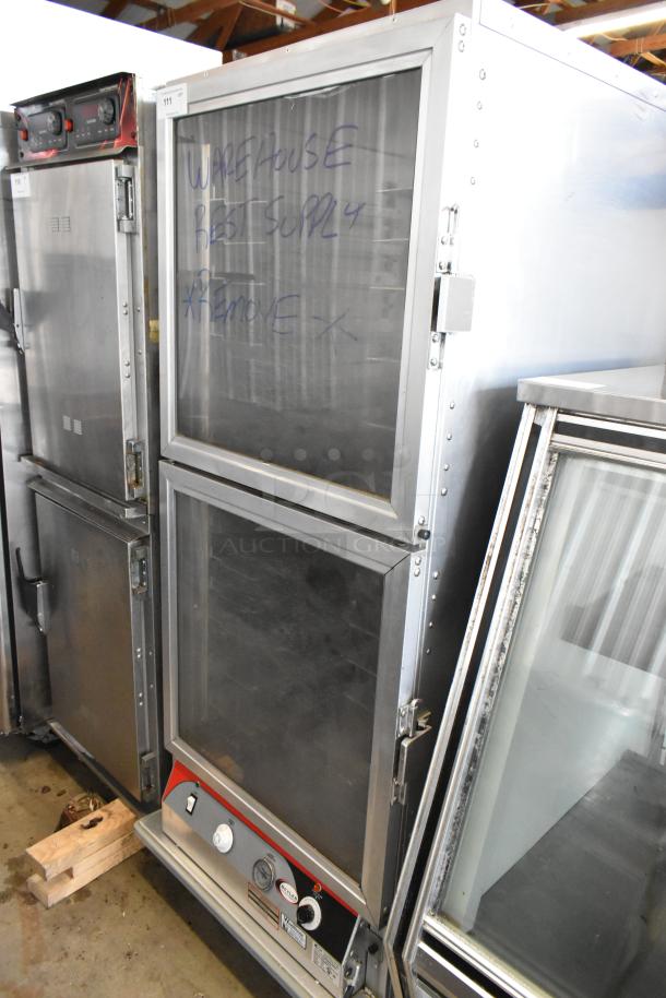 BevLes PHC70-MP17INS heated holding cabinet on casters, 120V. Metal construction, used condition, visible dials and labels.