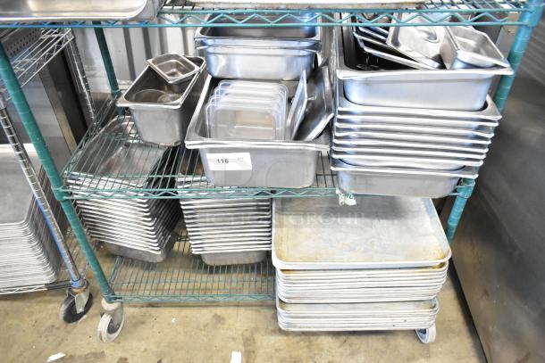 Two-tier lot with metal baking pans and stainless steel drop-in bins on a wheeled rack. Tag marked "116 QTY." Variety of sizes.