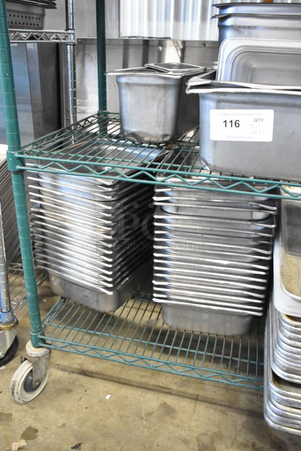 Two-tier metal rack with various metal baking pans and stainless steel drop-in bins with lids, some marked "116 QTY."