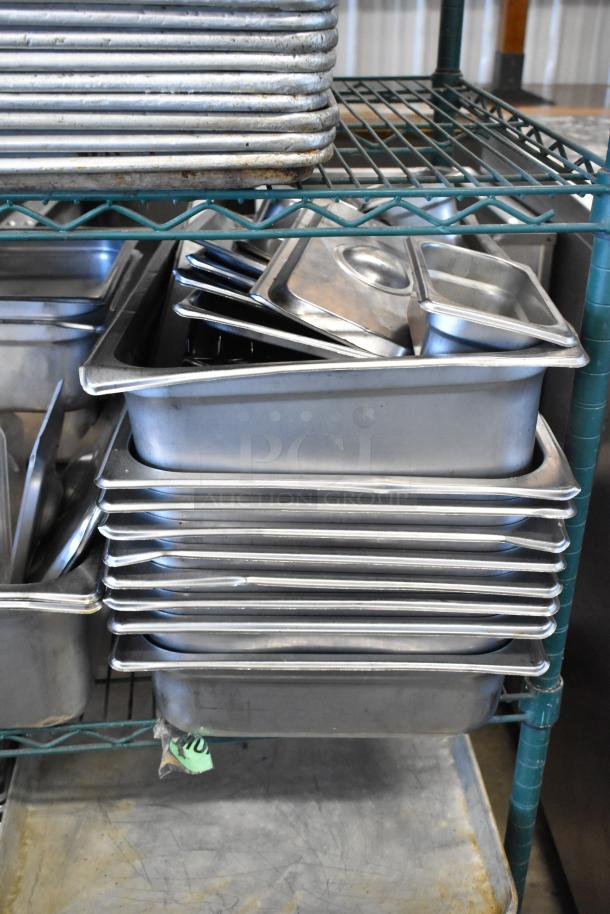 Two-tier lot of metal baking pans and stainless steel drop-in bins with lids, displayed on a rack. Visible wear on items.