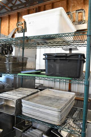 Three-tier shelving with metal baking pans, stainless steel drop-in bins, and poly bus bins. Auction tag number 117 visible.