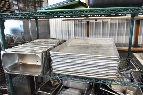 Three-tier lot with metal baking pans, stainless steel drop-in bins, and poly bus bins on wire shelving. Mixed condition.