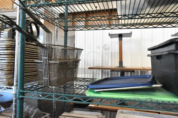 Three tier lot with metal baking pans, stainless steel drop-in bins, and poly bus bins on wire shelving.