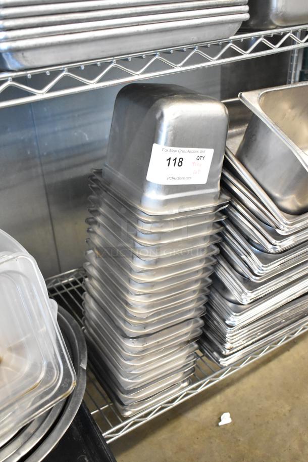Stacked stainless steel drop-in bins, metal baking pans, bowls on shelves; tag indicates auction lot 118.