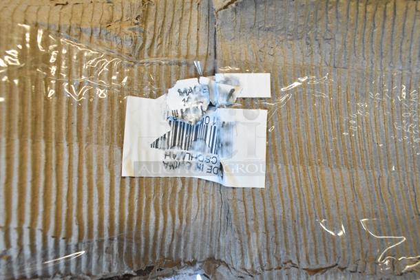 Cardboard packaging with a torn label, partially showing a barcode, related to chairs listed as scratch and dent items.