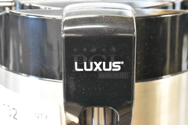 BRAND NEW Fetco Luxus LGD-20 2 Gallon Stainless Steel Coffee Dispenser. Minor scratches, featuring Luxus branding on black finish.
