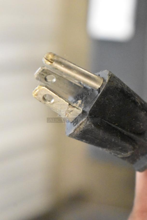 Close-up of plug on Schumacher SE-2352-CA Battery Charger. Item is brand new with scratch and dent condition.