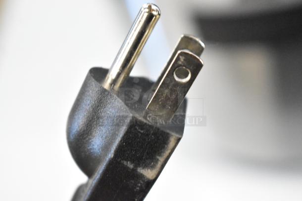 Close-up of a plug for the Galaxy 177RWGB90 electric rice warmer, highlighting 120V compatibility.