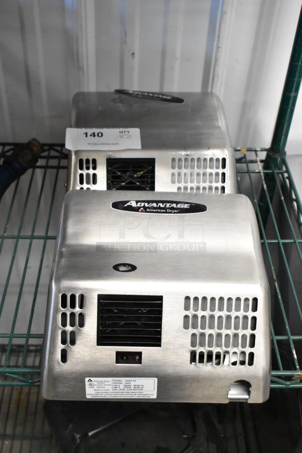 2 new American Dryer AD90-SS hand dryers with stainless steel covers. Model label and scratch visible. 100/240V, 1 phase.