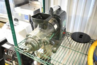 Countertop juice extractor machine, vintage appearance, metal body, visible wear, model identifier partially obscured.