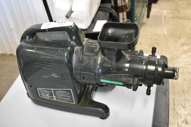 Countertop juice extractor machine, labeled "Green Power," in used condition. Features a motor housing and feeding chute.