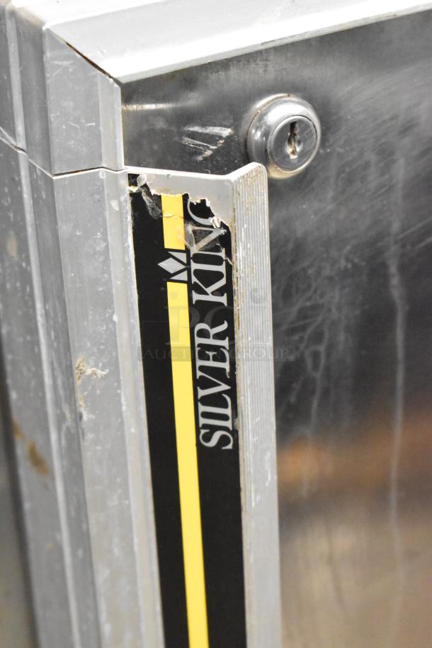Silver King SKF27 stainless steel undercounter freezer, single door, visible wear, 115 volts, 1 phase, brand label shown.