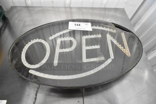 Light Up Open Sign, oval shape with LED lights, black frame, visible wear, auction tag attached with number 144.