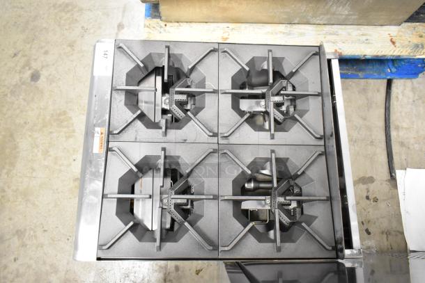 Brand new Cooking Performance Group R-CPG-24-NL 4 burner natural gas countertop range, 88,000 BTU, stainless steel, slight dents.