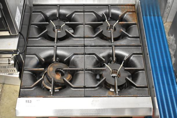 Brand new 2025 Avantco 177CAGR424 stainless steel 4 burner gas countertop range, 100,000 BTU, slight scratches and dents visible.