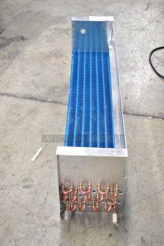 Brand new scratch and dent SDKH 5R7K745L evaporator coil, blue fins, copper tubing, minor surface marks on metal casing.