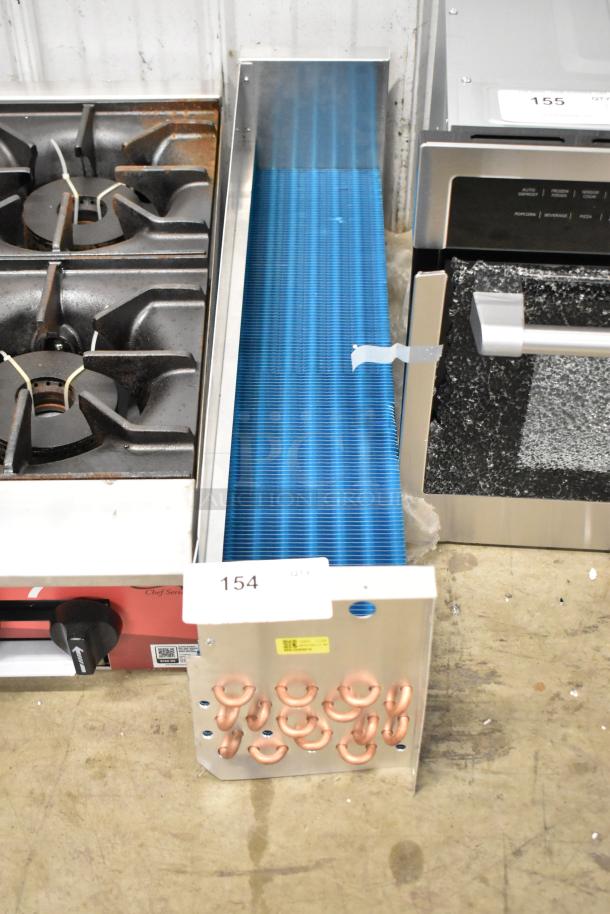 Brand new SDKH 5R7K745L evaporator coil, blue fins, copper tubing, minor scratches, auction tag 154 visible.