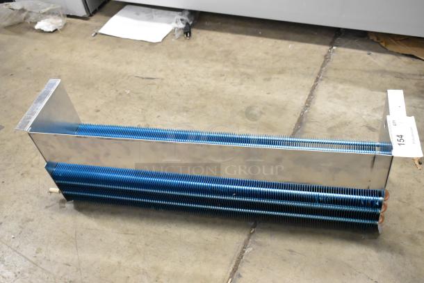 Brand new SDKH 5R7K745L evaporator coil, scratch and dent condition, blue fins, metal casing, visible auction tag 154.