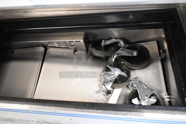 2025 Avantco 447APST72 stainless prep table under construction, showing interior wheels and components, scratch and dent model.