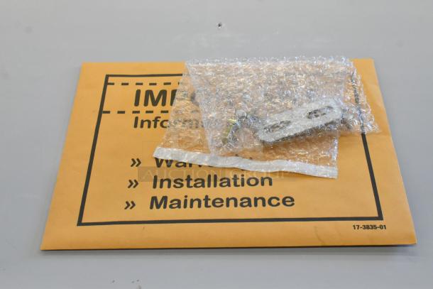 Envelope labeled "Information" with a bubble-wrapped package on top, possibly containing parts or accessories.